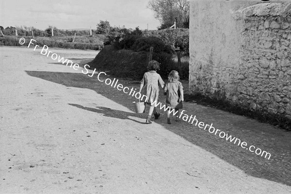 TWO CHILDREN WALKING WITH BUCKET